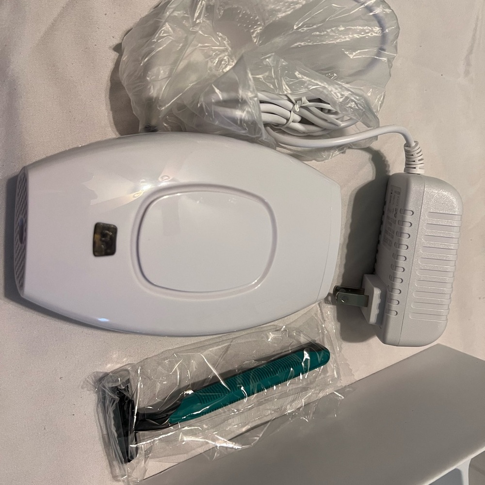 White Hair Removal Device with Teal Razor